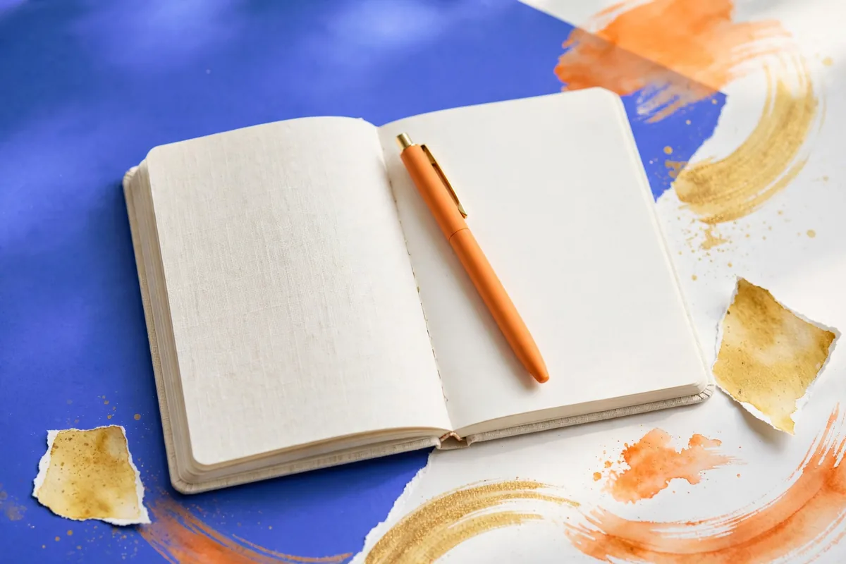 A notebook with a pen